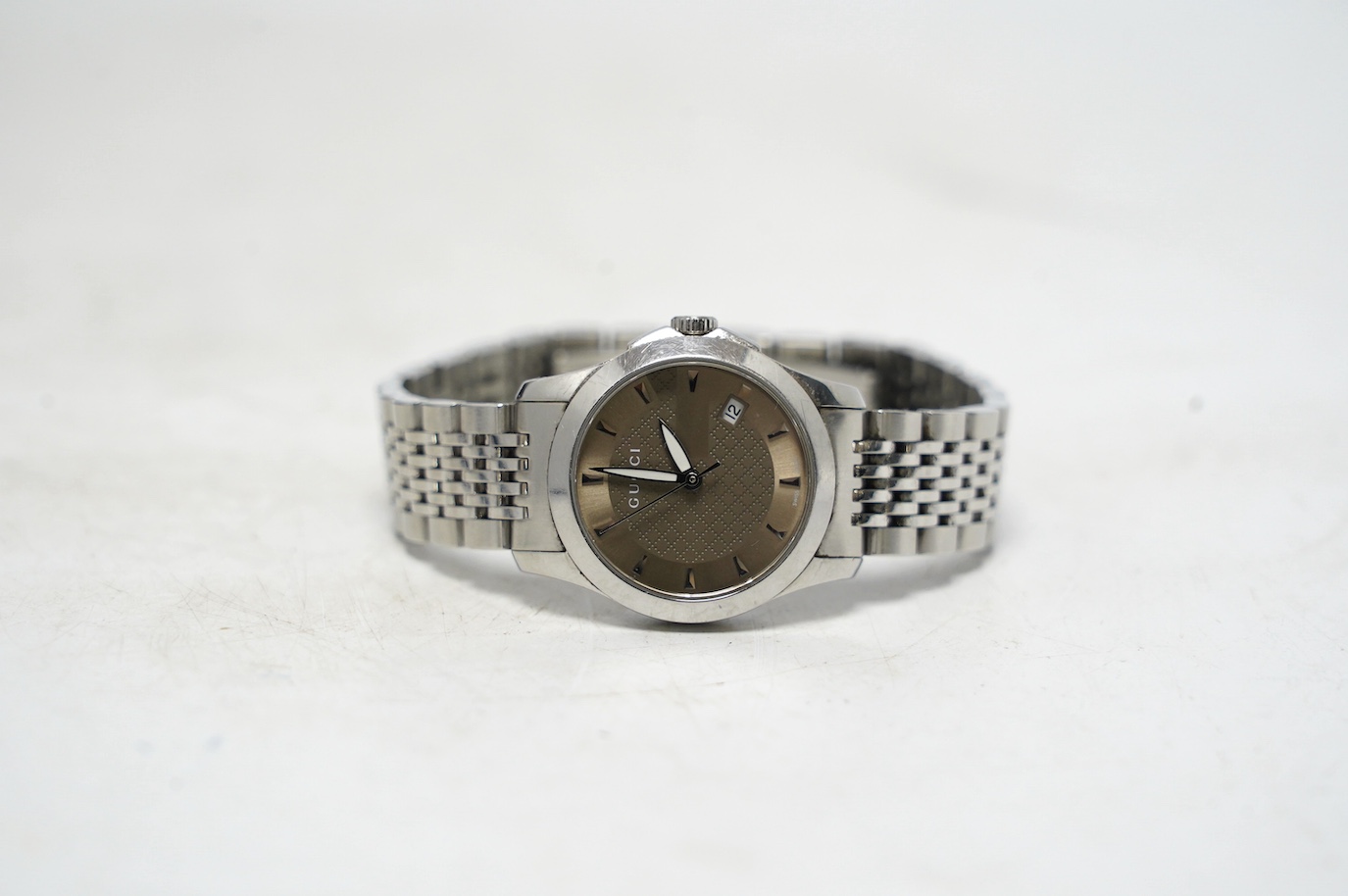 A lady's modern stainless Gucci quartz wrist watch, with date aperture, box and booklet. Condition - fair